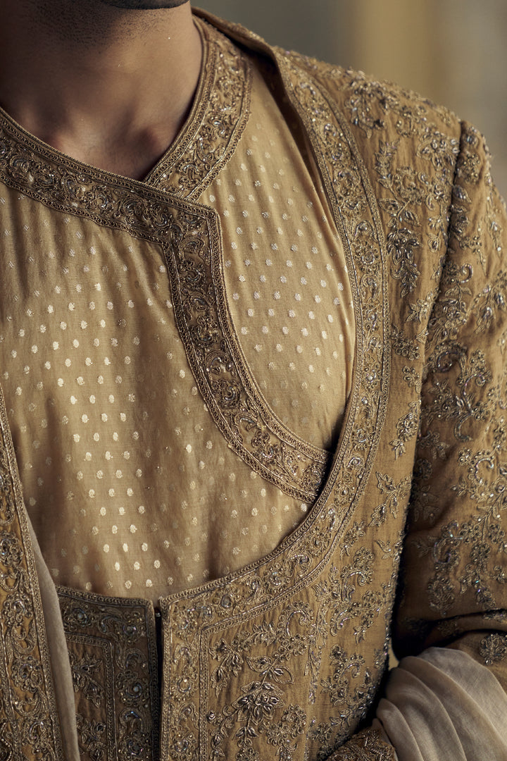 Gold Matka Silk Angrakha Style Sherwani With A Chanderi Booti Choga And Churidar