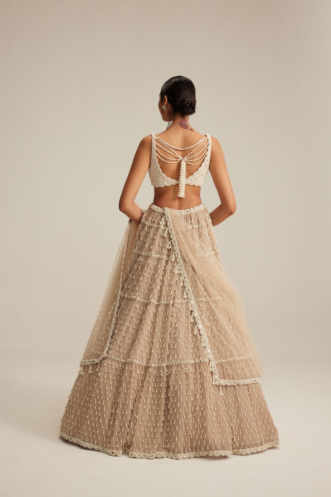 Light Beige Pearl Drop Multi Tier Lehenga Set.