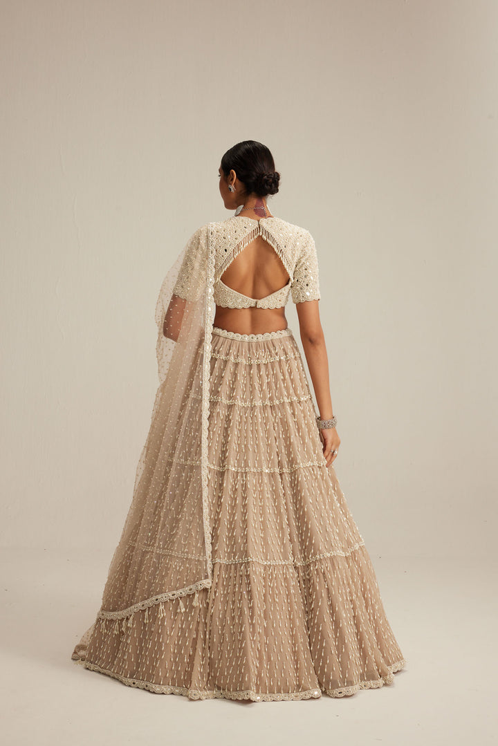Light Beige Pearl Drop Multi Tier Lehenga With High Neck Blouse Set.