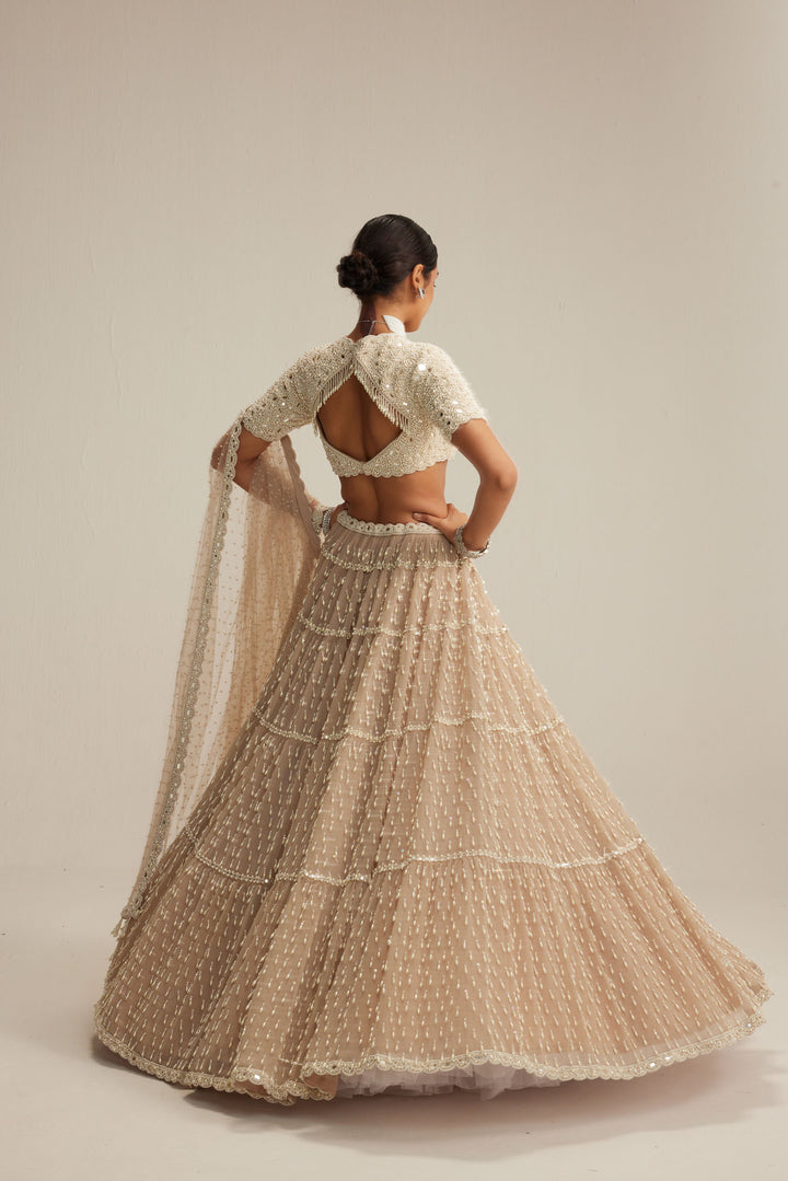 Light Beige Pearl Drop Multi Tier Lehenga With High Neck Blouse Set.